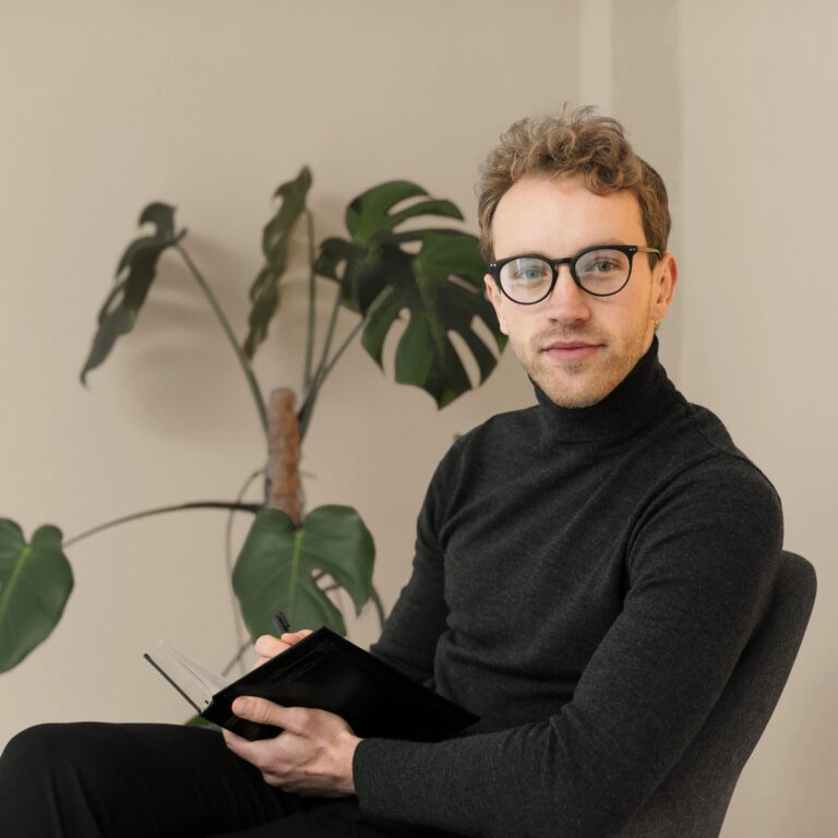 businessman-with-glasses-holding-book